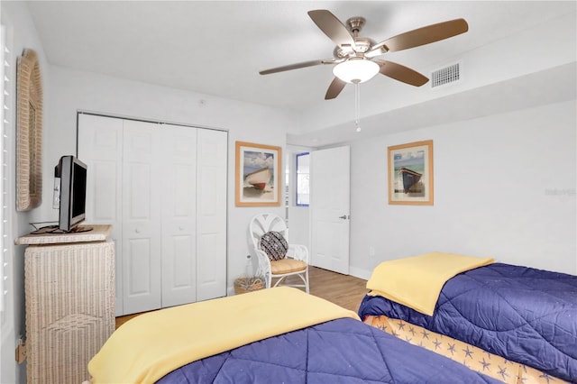 bedroom featuring ceiling fan, a closet, and wood-type flooring