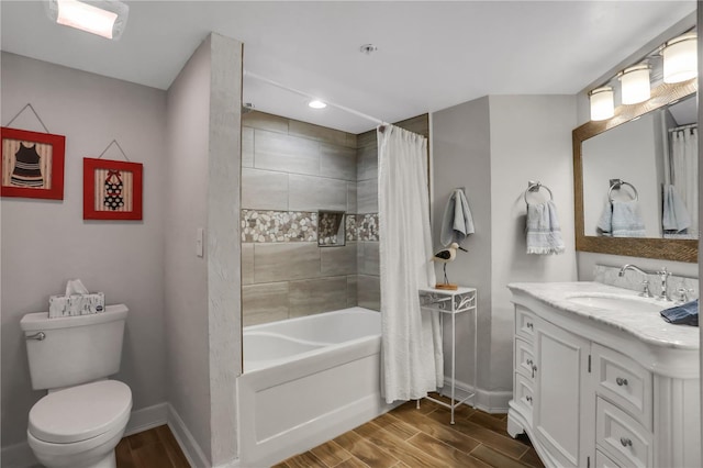 full bathroom with vanity, shower / bathtub combination with curtain, wood-type flooring, and toilet