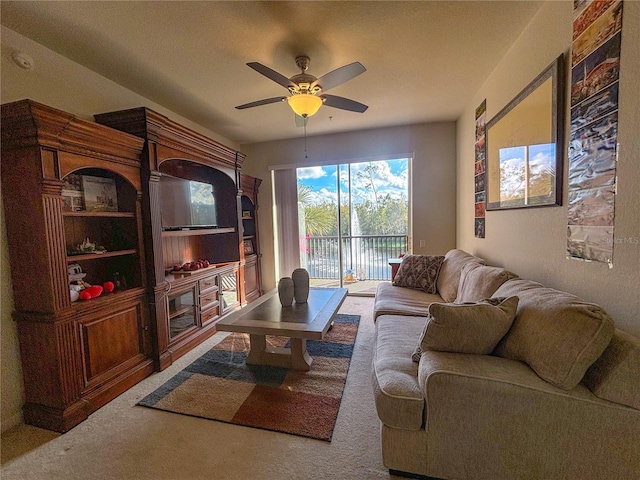 carpeted living room featuring ceiling fan