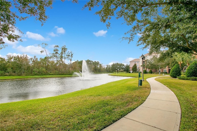 surrounding community featuring a water view and a yard