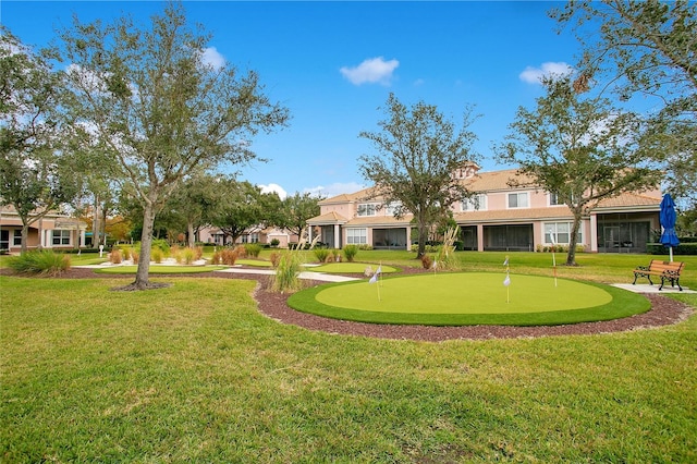 view of home's community with a yard