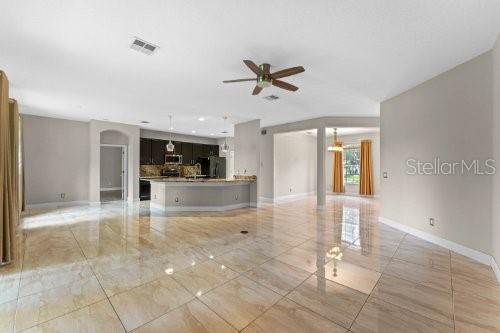 unfurnished living room featuring ceiling fan