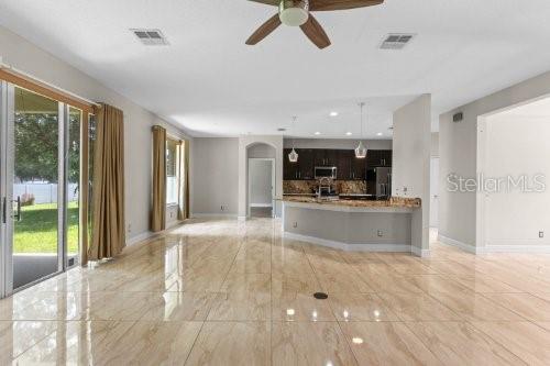 unfurnished living room featuring ceiling fan