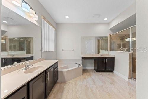 bathroom featuring plus walk in shower and vanity