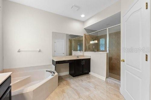 bathroom with separate shower and tub and vanity