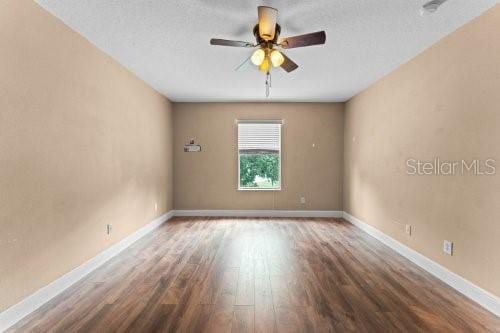 spare room with hardwood / wood-style flooring, ceiling fan, and a textured ceiling