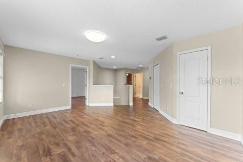 unfurnished living room featuring hardwood / wood-style flooring