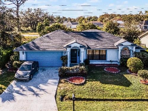 ranch-style house with a garage and a front yard