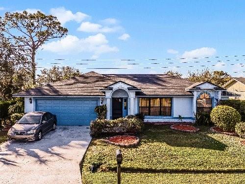 ranch-style house with a garage and a front yard