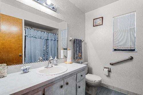 bathroom featuring tile patterned floors, vanity, and toilet