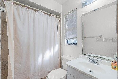 bathroom featuring vanity and toilet