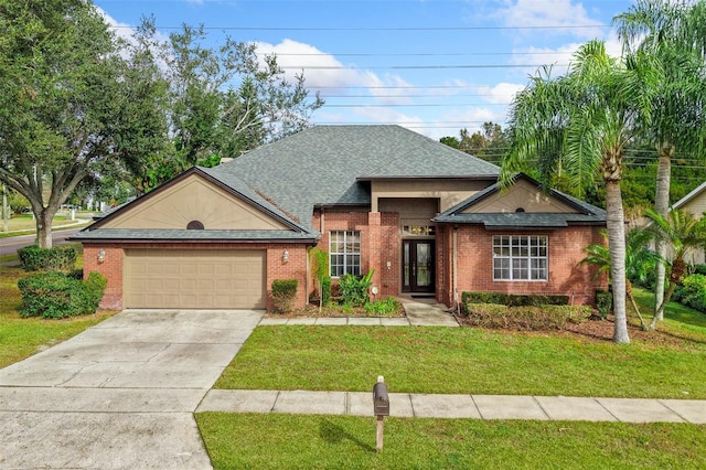 view of front of home with a garage and a front lawn