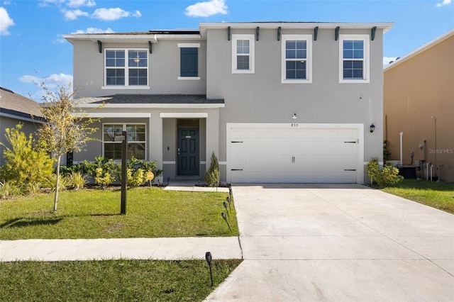 view of front of home featuring a front lawn and a garage