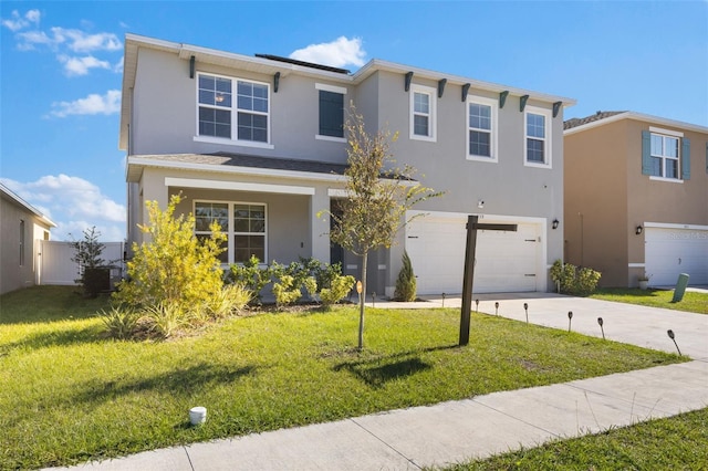 view of front of property featuring a garage and a front lawn