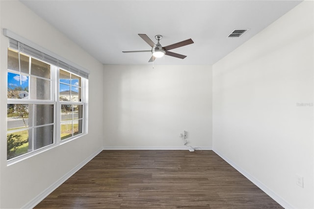 empty room featuring ceiling fan and dark wood-type flooring