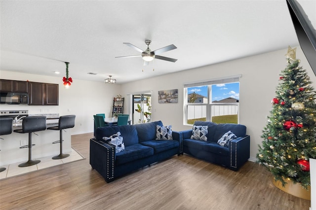 living room with ceiling fan and light wood-type flooring