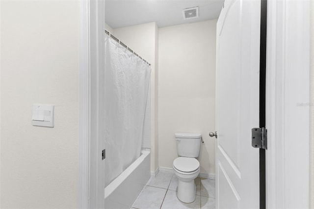 bathroom with tile patterned flooring, toilet, and shower / bath combo with shower curtain