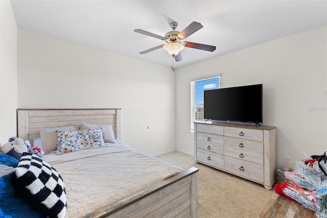 bedroom with ceiling fan and light carpet