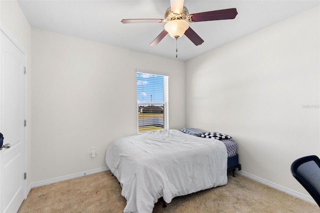 bedroom featuring light colored carpet and ceiling fan