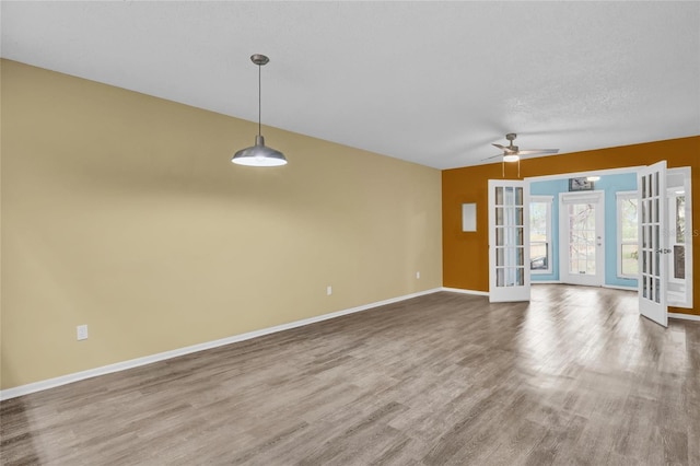 interior space with french doors, a textured ceiling, ceiling fan, and hardwood / wood-style floors