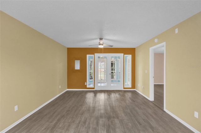 empty room with ceiling fan, wood-type flooring, and french doors