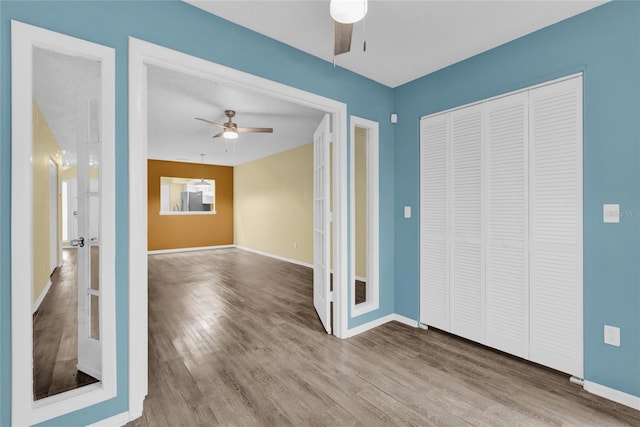 interior space with hardwood / wood-style floors and ceiling fan