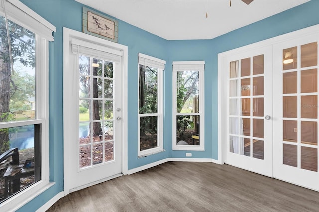 unfurnished sunroom with plenty of natural light and french doors