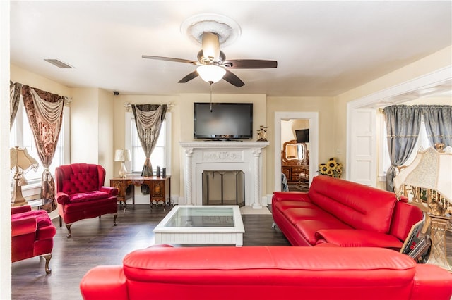 living room featuring ceiling fan and dark hardwood / wood-style flooring