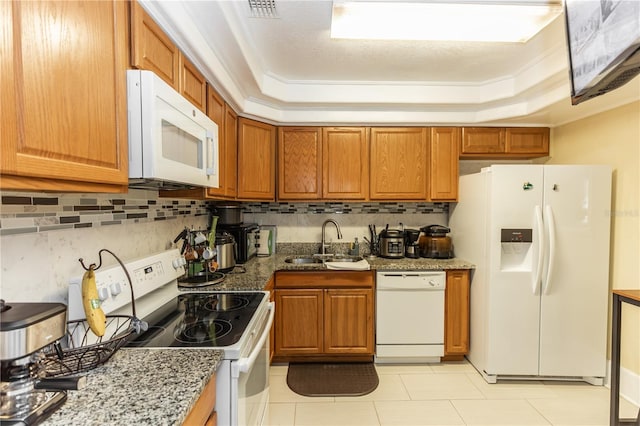 kitchen featuring crown molding, white appliances, sink, and a tray ceiling