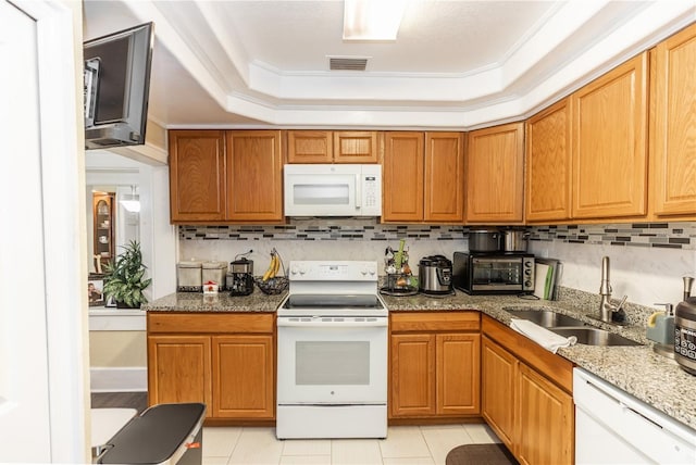 kitchen with light tile patterned flooring, crown molding, white appliances, and sink