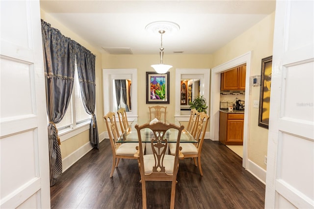 dining area with dark hardwood / wood-style floors