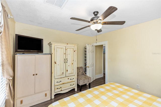 unfurnished bedroom with ceiling fan and dark hardwood / wood-style flooring