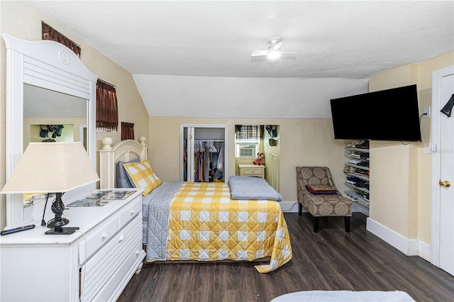 bedroom featuring a closet, a spacious closet, ceiling fan, and dark wood-type flooring