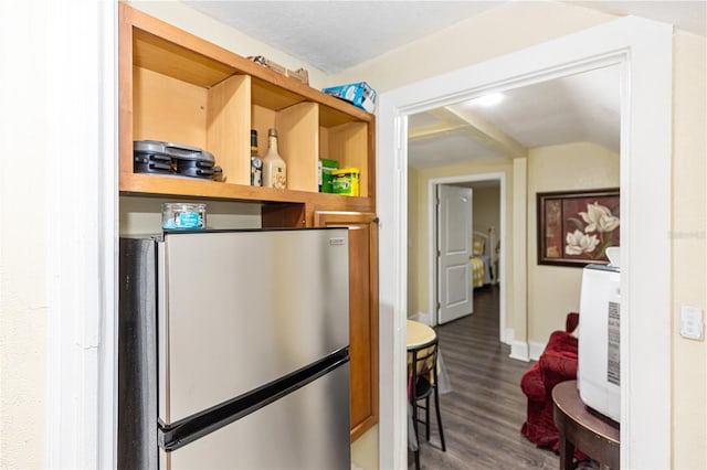 kitchen with stainless steel fridge and hardwood / wood-style floors