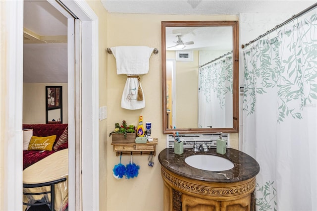 bathroom with ceiling fan and vanity