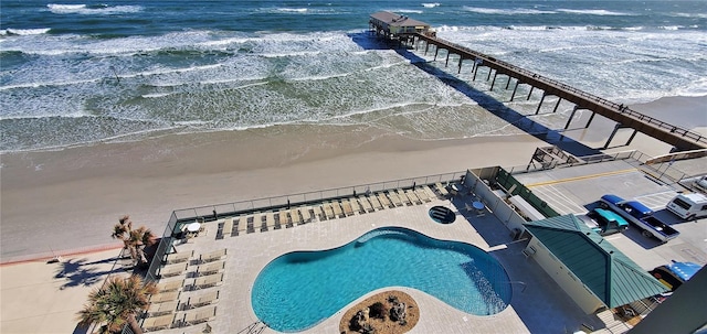 view of pool with a beach view and a water view