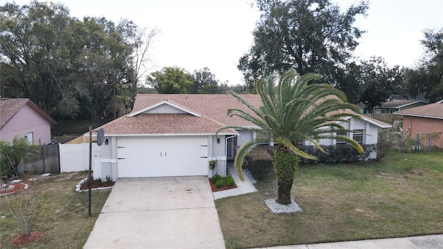 ranch-style house with a garage and a front lawn