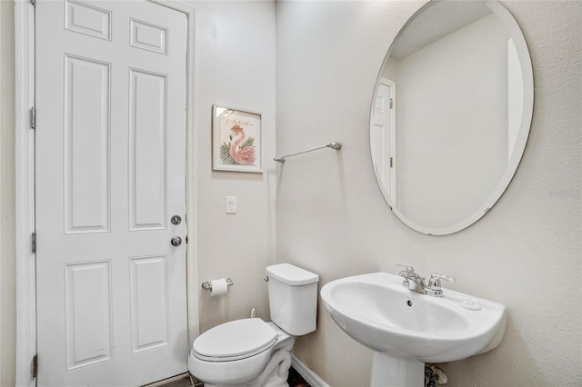 bathroom featuring toilet and sink