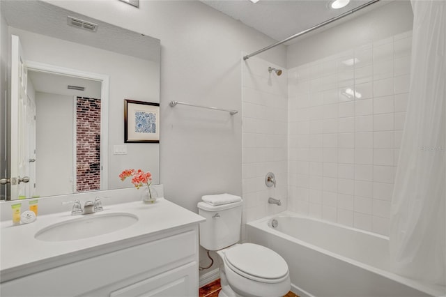 full bathroom featuring shower / bath combination with curtain, vanity, a textured ceiling, and toilet