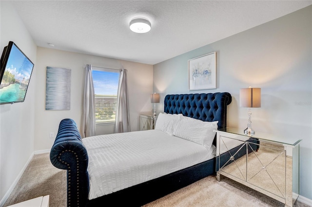 carpeted bedroom with a textured ceiling