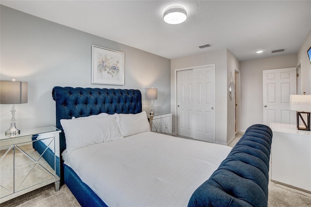 bedroom featuring light carpet and a closet