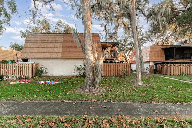 view of side of property with a lawn