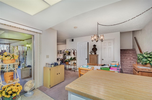 kitchen with hanging light fixtures, carpet, and a chandelier