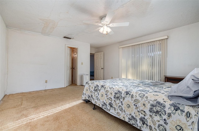 bedroom with carpet flooring, a textured ceiling, and ceiling fan