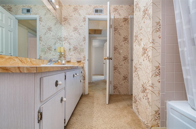 bathroom with shower / bath combo and vanity