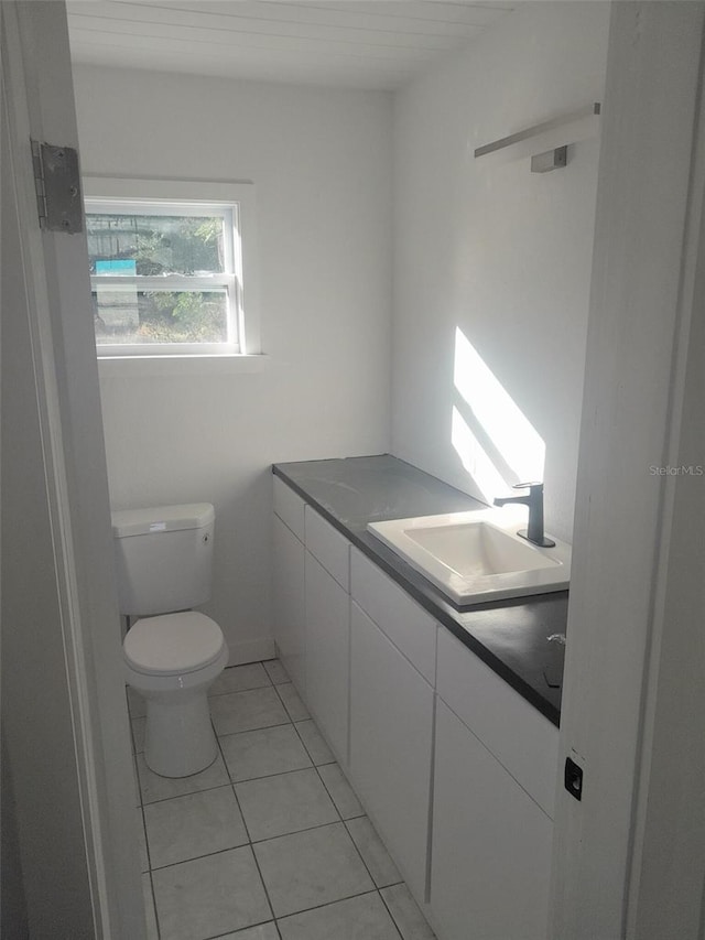 bathroom featuring tile patterned floors, vanity, and toilet