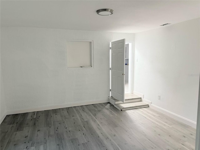 spare room featuring light hardwood / wood-style flooring