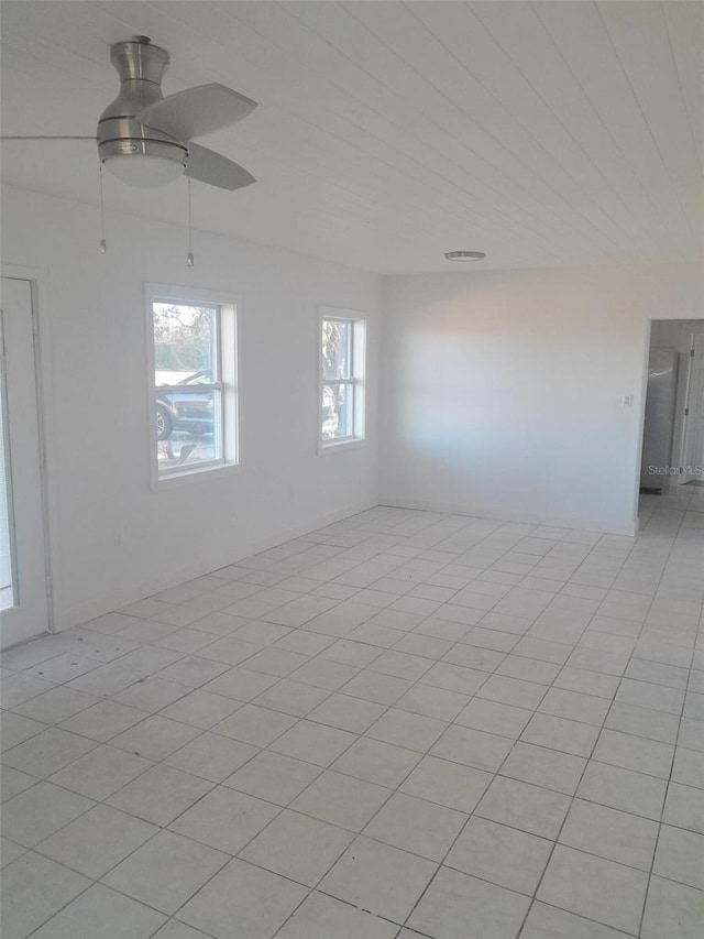 empty room with light tile patterned floors and ceiling fan