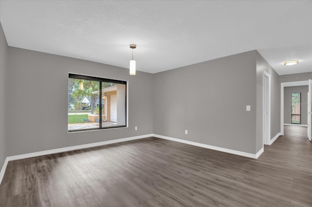 empty room featuring dark wood-type flooring