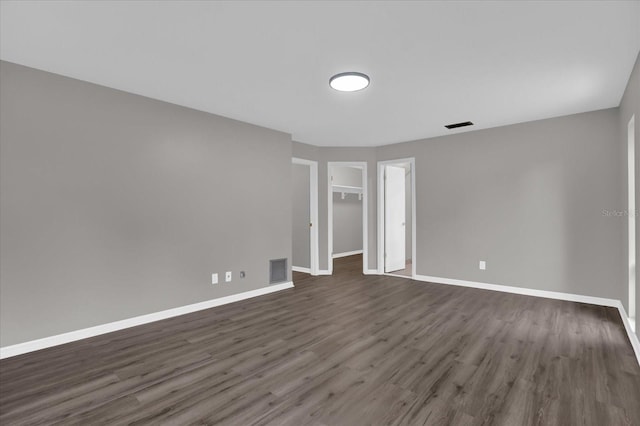 empty room with dark wood-type flooring